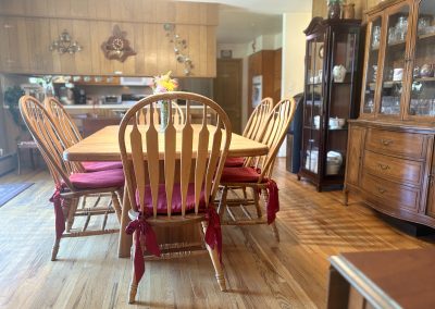 Spacious dining room with large wooden table and purple cushioned chairs at Travel Magick Spiritual Retreat Center main house Colorado