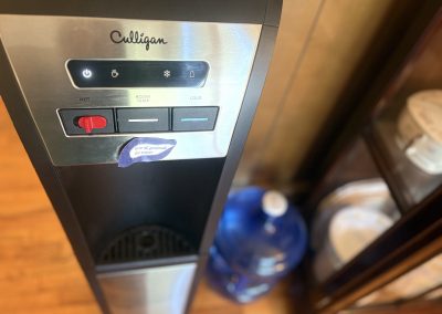 Laundry facilities and water dispenser in main house at Travel Magick Spiritual Retreat Center Colorado