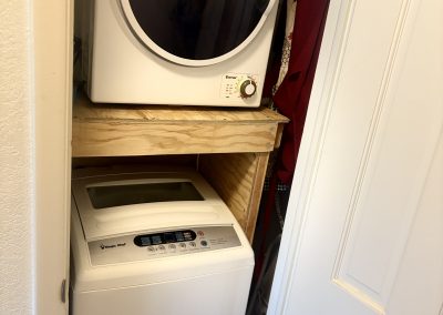 Laundry facilities and water dispenser in main house at Travel Magick Spiritual Retreat Center Colorado