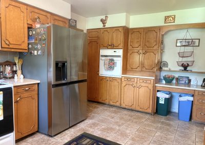 Fully equipped kitchen with modern appliances and wooden cabinets at Travel Magick Spiritual Retreat Center main house Colorado