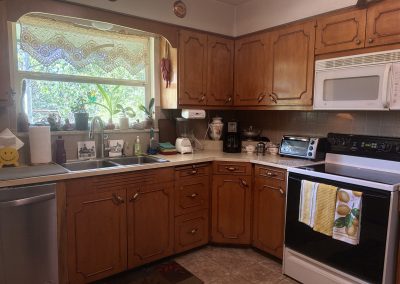 Fully equipped kitchen with modern appliances and wooden cabinets at Travel Magick Spiritual Retreat Center main house Colorado
