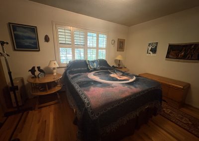 Magical fairy and moon bedding with butterfly pillow in bright bedroom at Travel Magick Spiritual Retreat Center main house Colorado