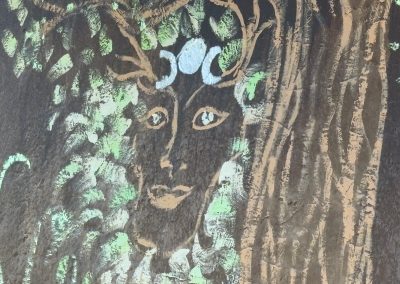 Sacred Green Man mural with triple moon goddess symbol painted on earth building wall at Travel Magick Spiritual Retreat Center