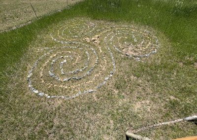 Sacred stone labyrinth with spiral pattern in mountain meadow at Travel Magick Spiritual Retreat Center Colorado